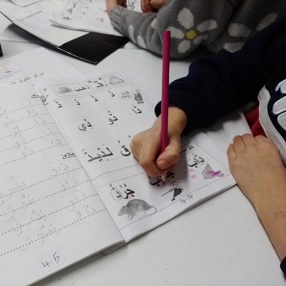 Picture of student drawing arabic words