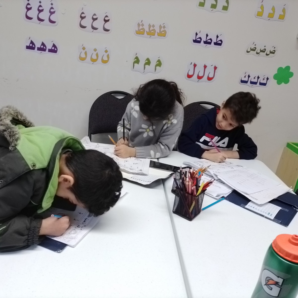 Picture of students writing in Arabic